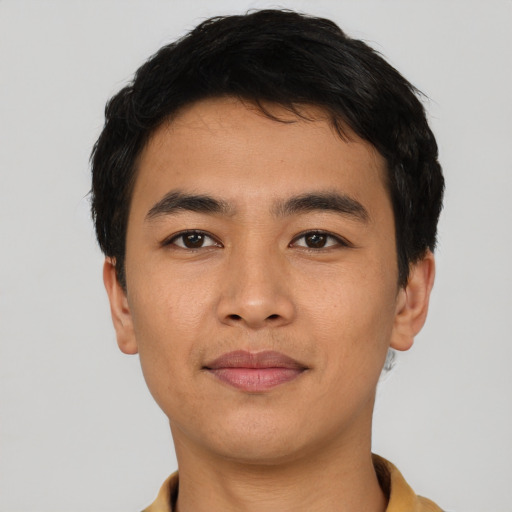 Joyful asian young-adult male with short  black hair and brown eyes