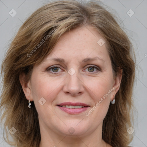 Joyful white adult female with medium  brown hair and grey eyes