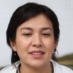 Joyful white adult female with medium  brown hair and brown eyes