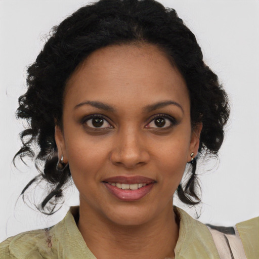 Joyful black young-adult female with medium  brown hair and brown eyes