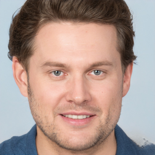 Joyful white adult male with short  brown hair and grey eyes