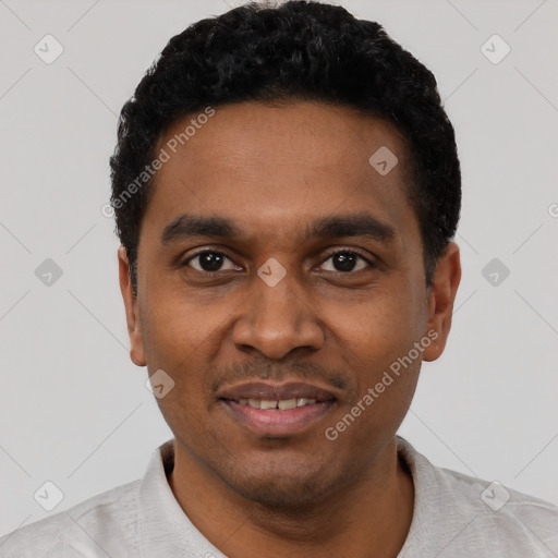 Joyful black young-adult male with short  black hair and brown eyes