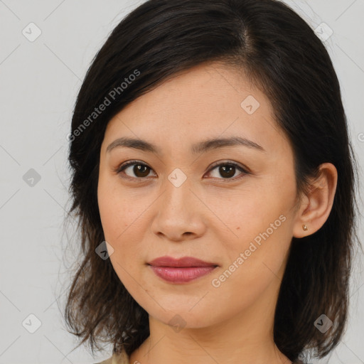 Joyful latino young-adult female with medium  brown hair and brown eyes