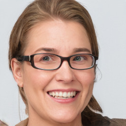 Joyful white adult female with medium  brown hair and blue eyes