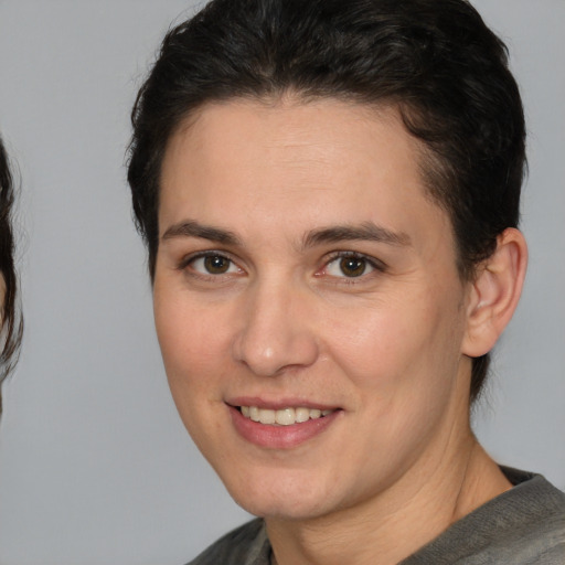 Joyful white adult female with medium  brown hair and brown eyes