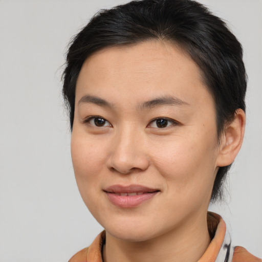 Joyful asian young-adult female with medium  brown hair and brown eyes