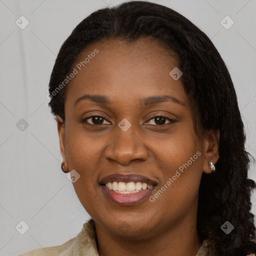 Joyful black young-adult female with long  black hair and brown eyes