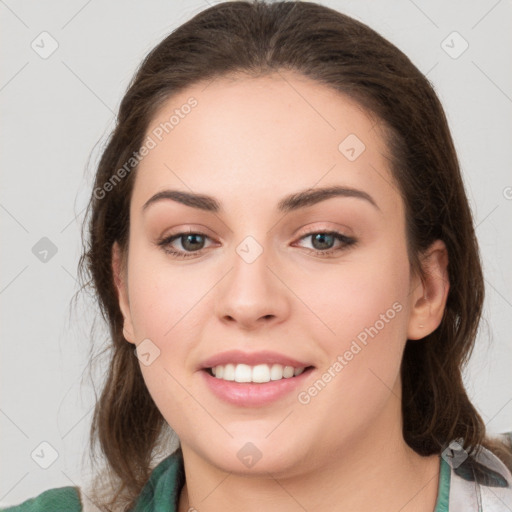 Joyful white young-adult female with medium  brown hair and green eyes