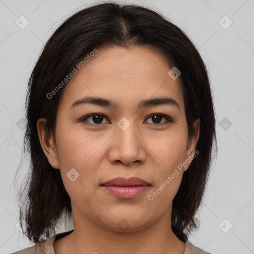 Joyful latino young-adult female with medium  brown hair and brown eyes