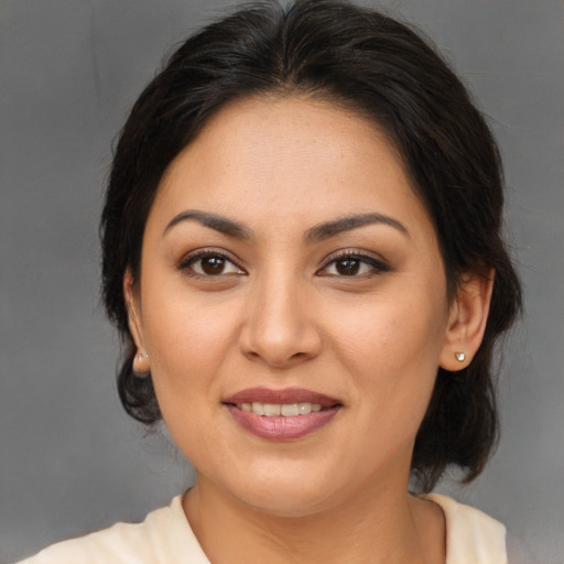 Joyful asian adult female with medium  brown hair and brown eyes