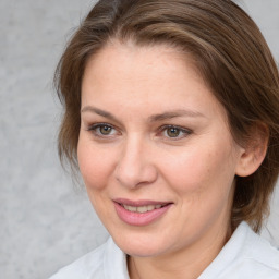 Joyful white adult female with medium  brown hair and brown eyes