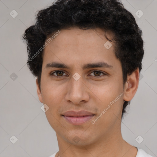 Joyful latino young-adult male with short  brown hair and brown eyes