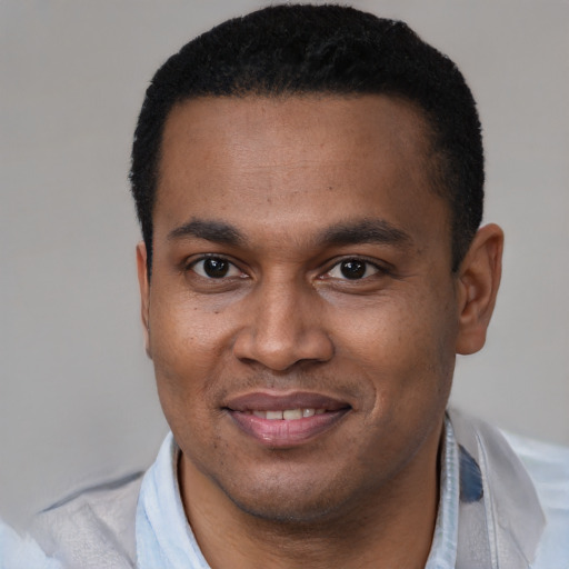Joyful latino young-adult male with short  brown hair and brown eyes
