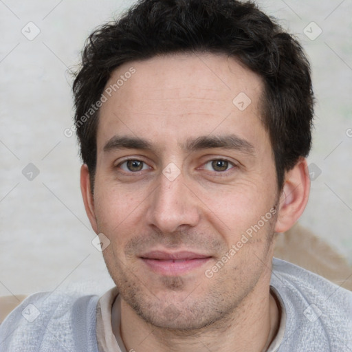 Joyful white adult male with short  black hair and brown eyes