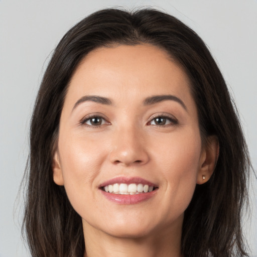 Joyful white young-adult female with long  brown hair and brown eyes