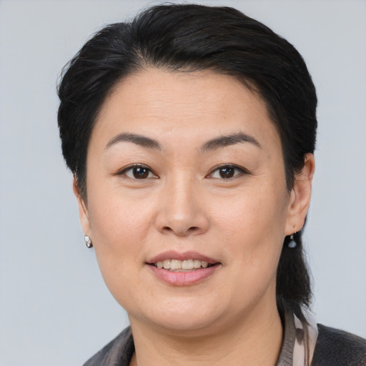 Joyful asian adult female with medium  brown hair and brown eyes