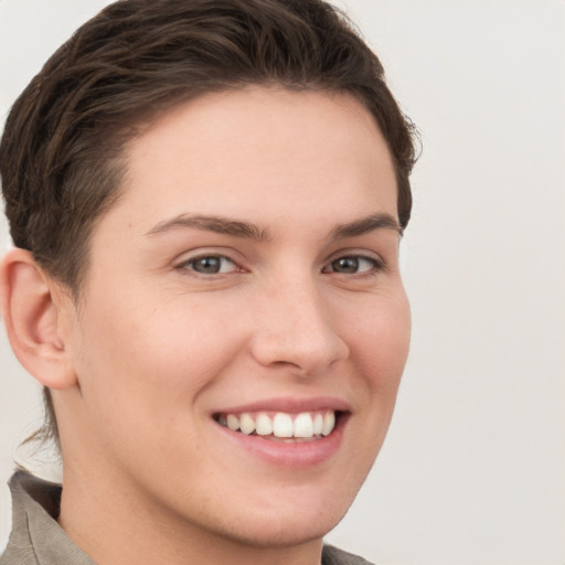 Joyful white young-adult female with short  brown hair and grey eyes