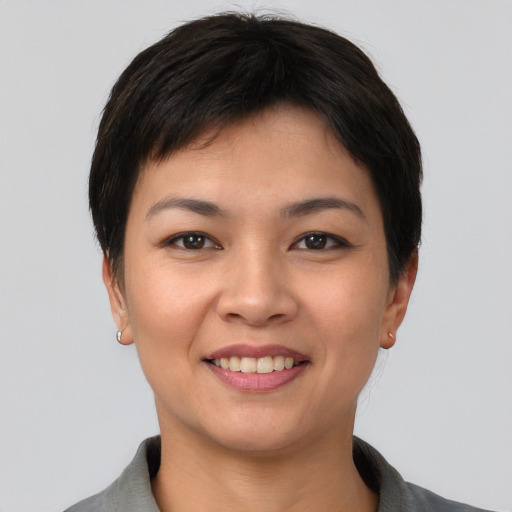 Joyful asian young-adult female with short  black hair and brown eyes