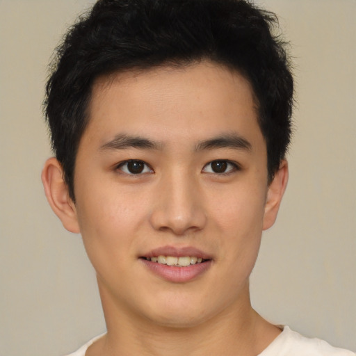 Joyful latino young-adult male with short  brown hair and brown eyes