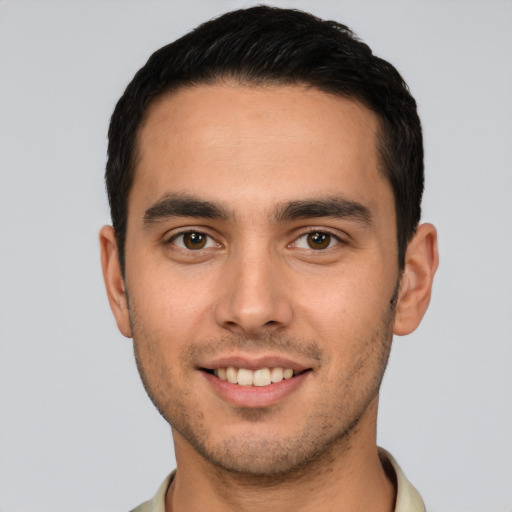 Joyful white young-adult male with short  brown hair and brown eyes