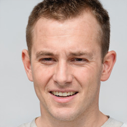 Joyful white adult male with short  brown hair and brown eyes