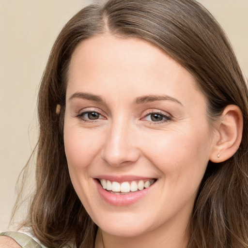 Joyful white young-adult female with long  brown hair and brown eyes