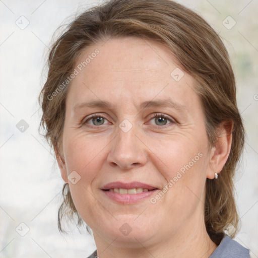 Joyful white adult female with medium  brown hair and grey eyes