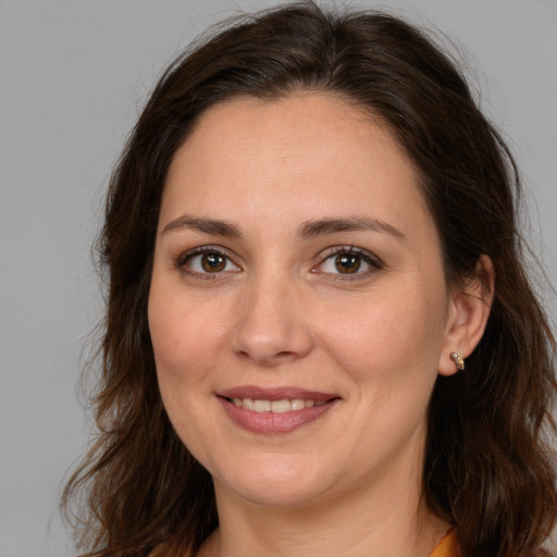 Joyful white young-adult female with medium  brown hair and brown eyes