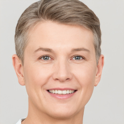 Joyful white adult male with short  brown hair and grey eyes