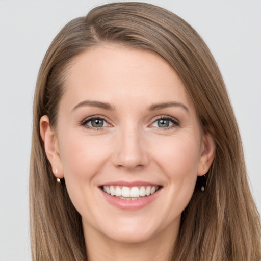 Joyful white young-adult female with long  brown hair and grey eyes