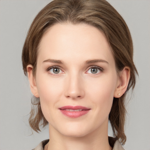 Joyful white young-adult female with medium  brown hair and grey eyes