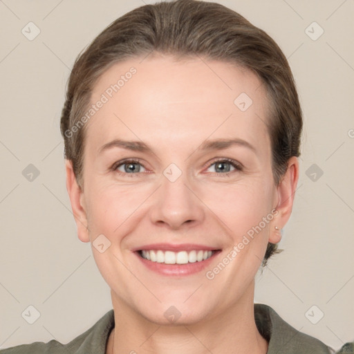 Joyful white adult female with short  brown hair and grey eyes