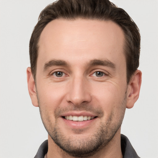 Joyful white young-adult male with short  brown hair and brown eyes