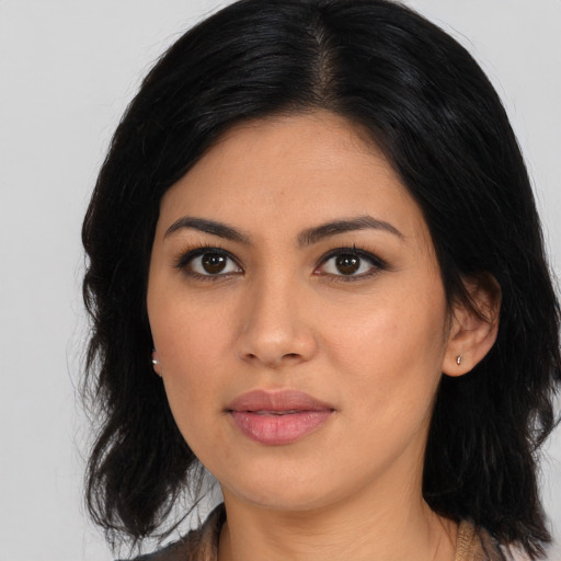 Joyful asian young-adult female with long  black hair and brown eyes