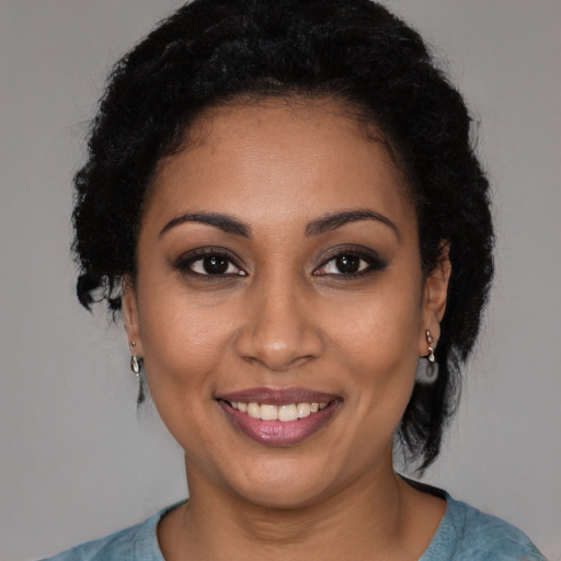 Joyful latino young-adult female with medium  brown hair and brown eyes
