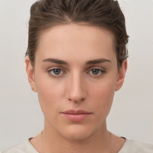 Neutral white young-adult female with short  brown hair and grey eyes