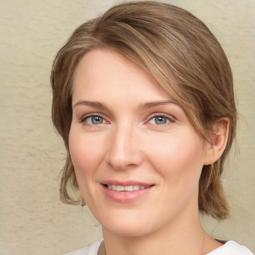 Joyful white young-adult female with medium  brown hair and green eyes