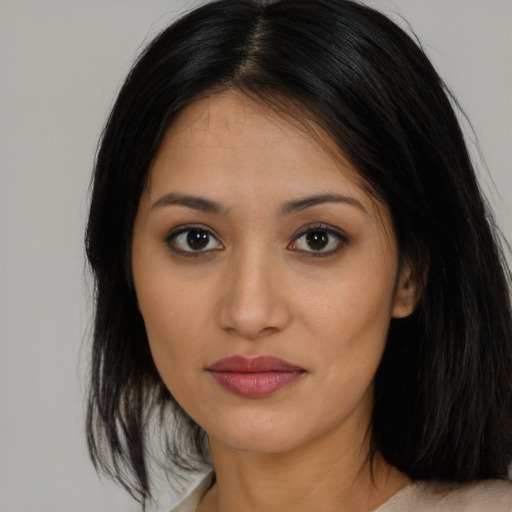 Joyful asian young-adult female with long  brown hair and brown eyes