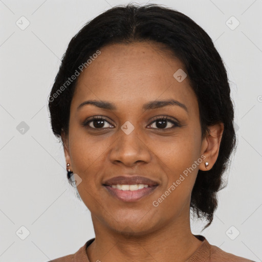 Joyful black young-adult female with short  black hair and brown eyes