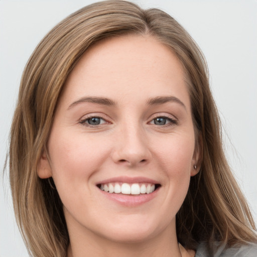 Joyful white young-adult female with long  brown hair and grey eyes