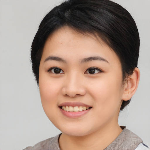 Joyful asian young-adult female with medium  black hair and brown eyes