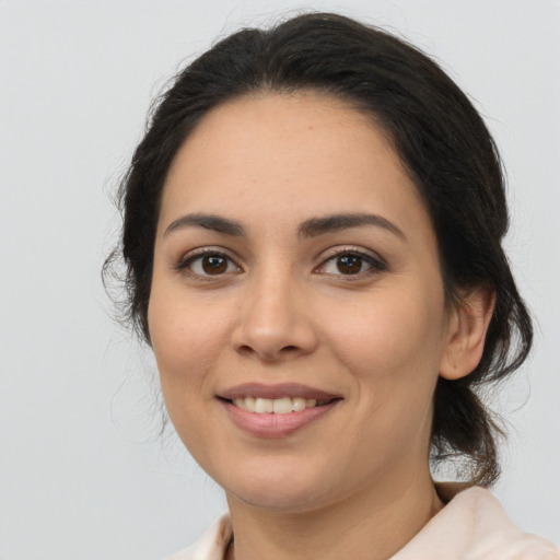 Joyful latino young-adult female with medium  brown hair and brown eyes