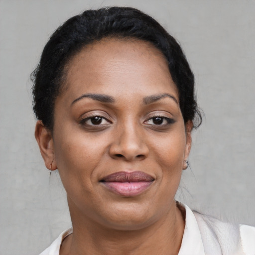 Joyful black adult female with short  brown hair and brown eyes