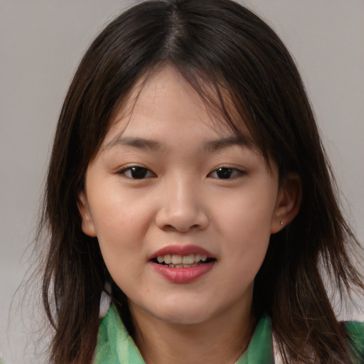 Joyful asian child female with medium  brown hair and brown eyes