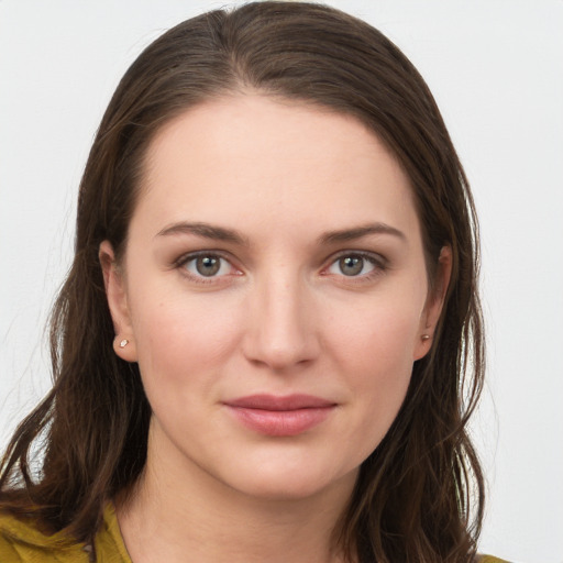 Joyful white young-adult female with long  brown hair and grey eyes