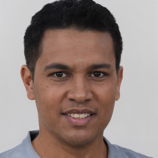 Joyful white young-adult male with short  black hair and brown eyes