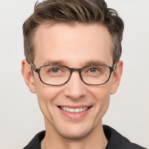 Joyful white adult male with short  brown hair and grey eyes