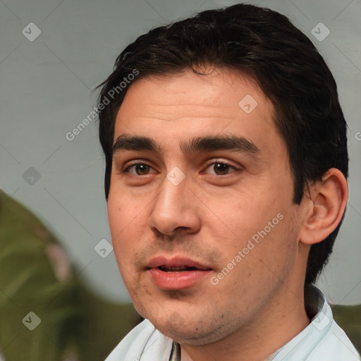 Joyful white young-adult male with short  black hair and brown eyes