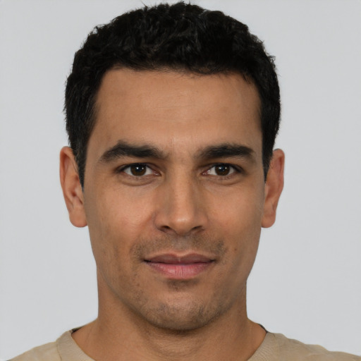 Joyful latino young-adult male with short  black hair and brown eyes