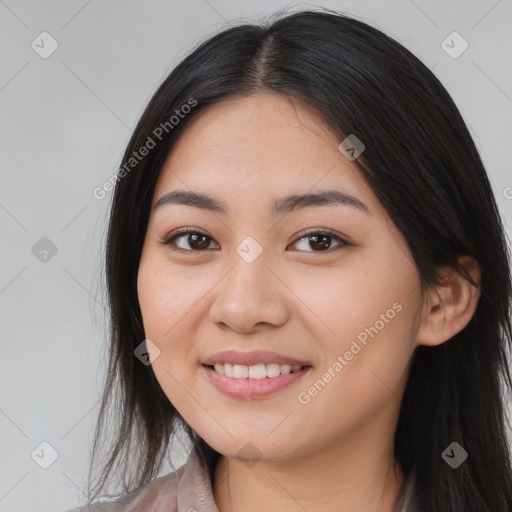 Joyful asian young-adult female with long  brown hair and brown eyes